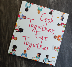 White book with title "Cook Together, Eat Together"