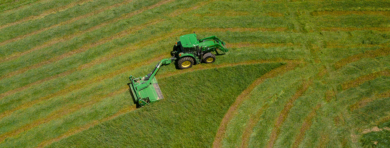 Tractor mowing hay