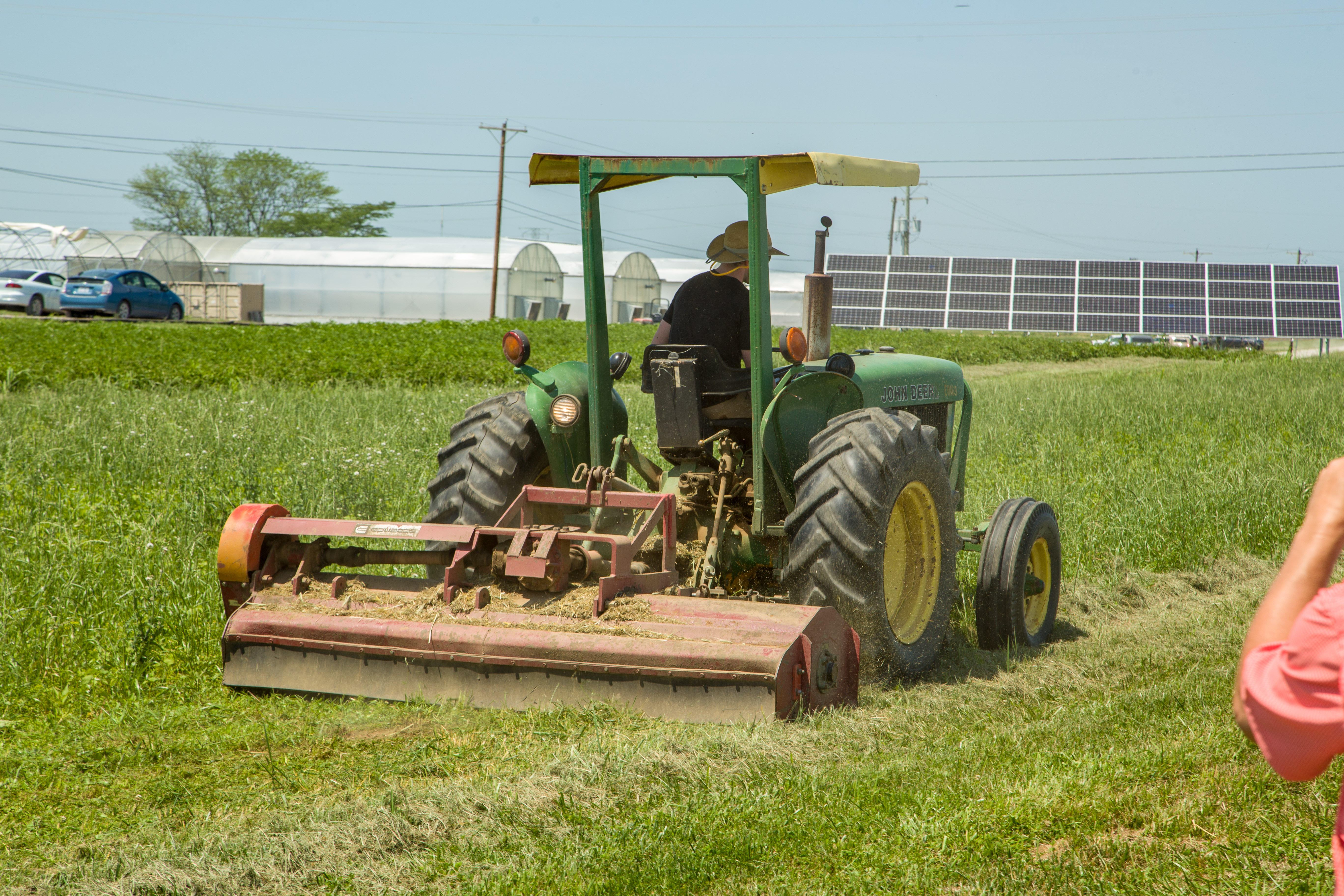 man on tractor mowing weeds